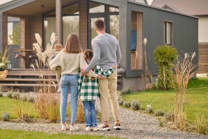 Family viewing a maintained home exterior with garden path, showing ActivePropertyCare.com property care for safer maintained homes.
