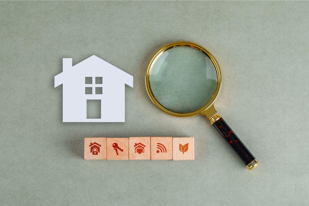 House icon with magnifying glass and service symbols showing Info ActivePropertyCare.com property inspections and care areas.