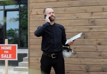 How to Manage a Rental Property: Tenants, Maintenance, Inspections, and Records Property manager holding a clipboard outside a residential rental property.