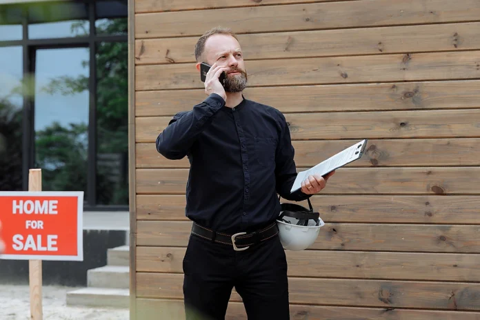 Property manager holding a clipboard outside a residential rental property.