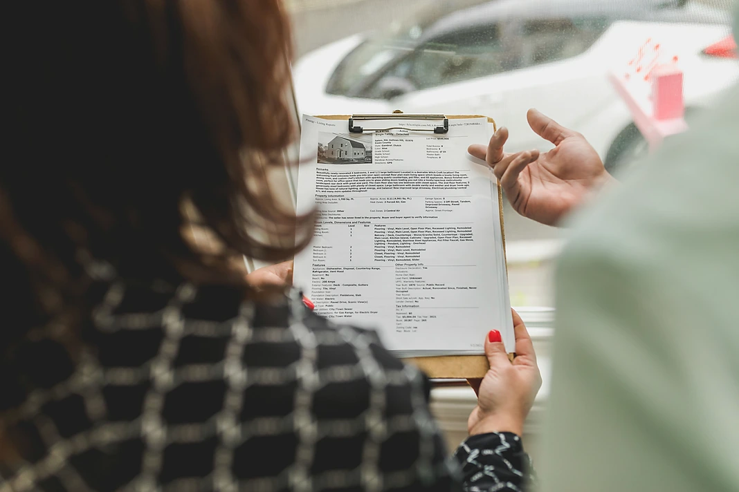Landlord and tenant reviewing rental property documents together