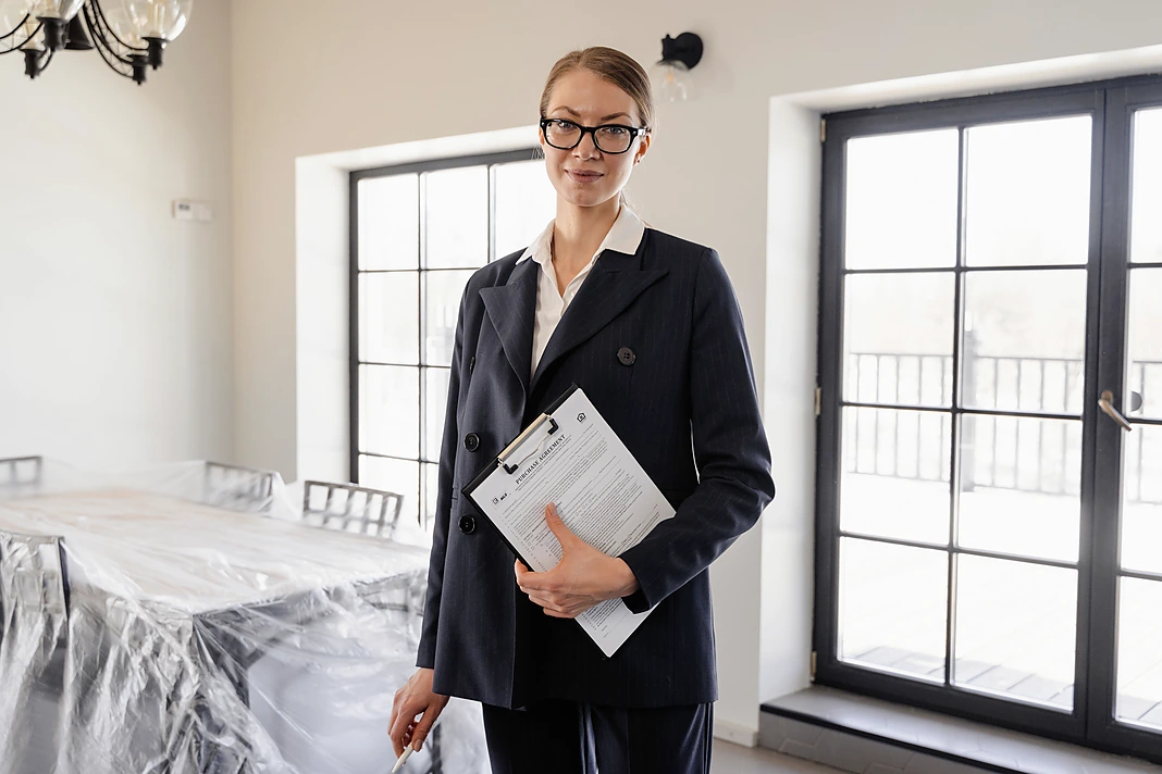 Property manager holding an inspection checklist inside a rental home