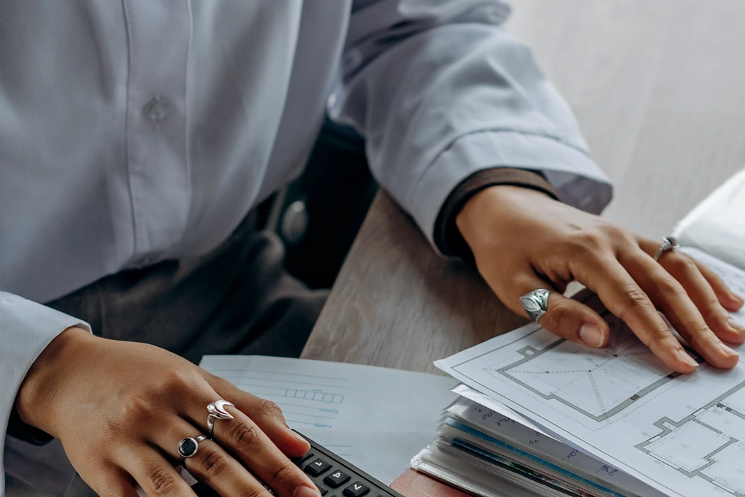 Home renovation budget tracker with calculator and construction drawings