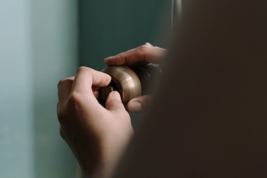 Door hardware being adjusted during a rental property repair