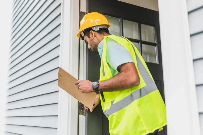 Property inspector documenting the exterior condition of a residential rental home.