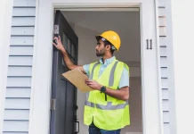 What Repairs Are Landlords Responsible For? Duties, Damage, and Repair Response Property inspector checking a rental home entrance while documenting a repair concern.